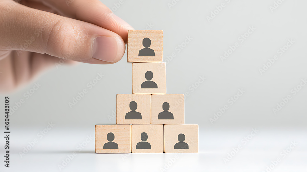 Photo Stock Building a team: Wooden blocks with person icons stacked by ...