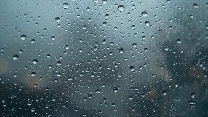 Poster - Moisture beads on a pane with rain in the background