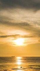 Wall Mural - Sky transform from sunset to a radiant twilight, with beautiful clouds painting the twilight horizon at a beach in the ocean.