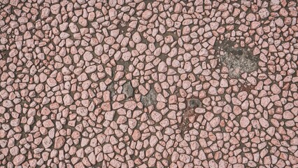 Poster - Textured pink pebble walkway showing signs of weathering, great for backgrounds