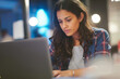 © wolfhound911 - A young Hispanic woman writes product launch email drafts, tailoring the voice and urgency of messaging for targeted customer groups.