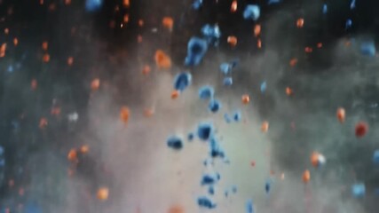 Poster - An abstract view of blue and orange particles suspended in a hazy, smoky atmosphere, creating a dynamic and textured effect.