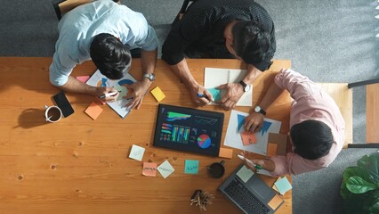 Poster - Top aerial view of diverse team writing colorful sticky notes to brainstorm marketing idea while looking at financial chart. Multicultural smart business people taking a note about plan. Convocation.