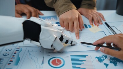 Poster - This image captures the collaboration between humans and robots in a modern workspace, showcasing data analysis through charts and graphs, emphasizing teamwork and technology.Noogenesis