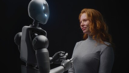 Fototapete - Futuristic Human-Machine Concept: Visualization of Young Woman Speaking with Advanced Humanoid Robot. People and Robots Working Together. Collaboration Between Humanity and Artificial Intelligence.