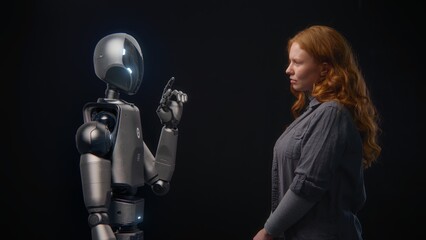 Fototapete - Futuristic Human-Machine Concept: Visualization of Young Woman Speaking with High-Tech Humanoid Robot. Symbol of Connection, Collaboration and Harmony Between Humanity and Artificial Intelligence.