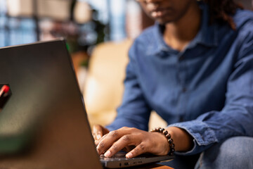 Poster - Tech savvy user working on a wireless laptop to test a new software, navigating new digital tools and managing virtual tasks. Connected and productive lifestyle from her home, living room space.