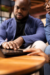 Poster - casual man and woman opening laptop on the coffee table to solve daily tasks, doing remote freelance