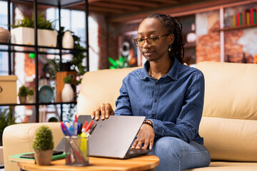 Poster - Independent woman using laptop for remote job tasks at home office, doing research and enjoying the benefits of schedule flexibility. Embracing the modern lifestyle of freelance work.
