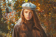 © Volodymyr - Woman walking through Autumn falling leaves. Romantic portrait of girl on yellow fall foliage. Beautiful woman holding a maple leaf. Caucasian girl on autumn outdoors. Outdoor lifestyle with fall