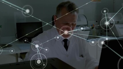 Poster - Senior scientist typing keyboard in lab generating network graph originating left spanning machines