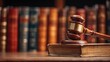 © Liu - Judge's gavel resting on a book in front of a row of law books.