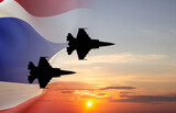 Silhouette of military airplane against the sunset with Thailand flag