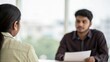 © N7 - Over-Shoulder Blurred Shot of Indian Interviewer Facing Candidate