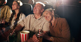 Senior couple, laugh and happy at cinema for movie in crowd, bonding and date with comedy show. Elderly people, smile and excited with fast food, popcorn and watch comic film with love at theater