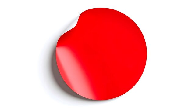 Bold red circular form with a subtle sheen casting soft shadow on white surface