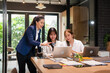 © Fahng - Professional young business woman manager explaining  solutions helping young employee at work.