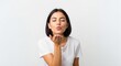© Eman Suardi - Young woman playfully blowing a kiss towards the camera, set against a clean white background