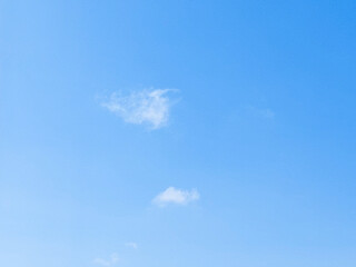 Wall Mural - Soft white clouds with a beautiful blue sky in the morning light. Soft white clouds float in the clear blue sky. Clear blue sky, bright spring, soft sky gradient.