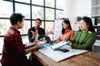 © Dino - Brainstorming of young modern group. Team meeting to achieve goal. Business people discussing finance business and analysis. Teamwork concept in modern office. Calculating personal tax for client.