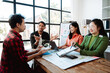 © Dino - Brainstorming of young modern group. Team meeting to achieve goal. Business people discussing finance business and analysis. Teamwork concept in modern office. Calculating personal tax for client.