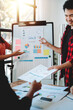© Dino - Brainstorming of young modern group. Team meeting to achieve goal. Business people discussing finance business and analysis. Teamwork concept in modern office. Calculating personal tax for client.