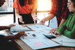 © Dino - Brainstorming of young modern group. Team meeting to achieve goal. Business people discussing finance business and analysis. Teamwork concept in modern office. Calculating personal tax for client.