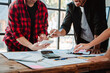 © Dino - Brainstorming of young modern group. Team meeting to achieve goal. Business people discussing finance business and analysis. Teamwork concept in modern office. Calculating personal tax for client.