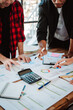 © Dino - Brainstorming of young modern group. Team meeting to achieve goal. Business people discussing finance business and analysis. Teamwork concept in modern office. Calculating personal tax for client.