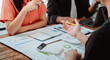 © Dino - Brainstorming of young modern group. Team meeting to achieve goal. Business people discussing finance business and analysis. Teamwork concept in modern office. Calculating personal tax for client.