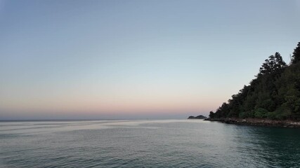 Wall Mural - sunrise on the coast with calm, rolling waves