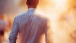 © Alena - Businessman in formal attire walking under extreme heat with sunlight flaring in the background. Concept of climate stress, heatwave impact, or urban environment in summer.