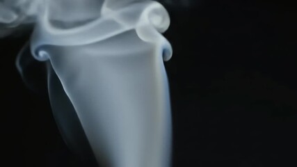Poster - Abstract video of white smoke swirling against black background, forming unique shapes and patterns, showcasing the ephemeral nature of time and transformation