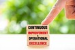 © Hunman - Continuous improvement and operational excellence text on wooden blocks.