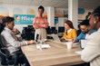 © Jelena - Diverse Team Collaborating in Modern Office Setting