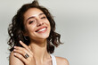 © LIGHTFIELD STUDIOS - Stunning young woman showcases elegant makeup and radiant smile in studio setting