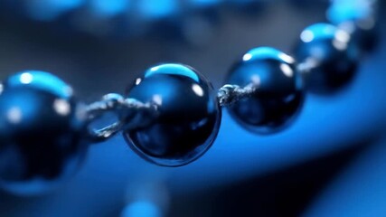 Poster - Glossy blue spheres linked by thread, soft focus background