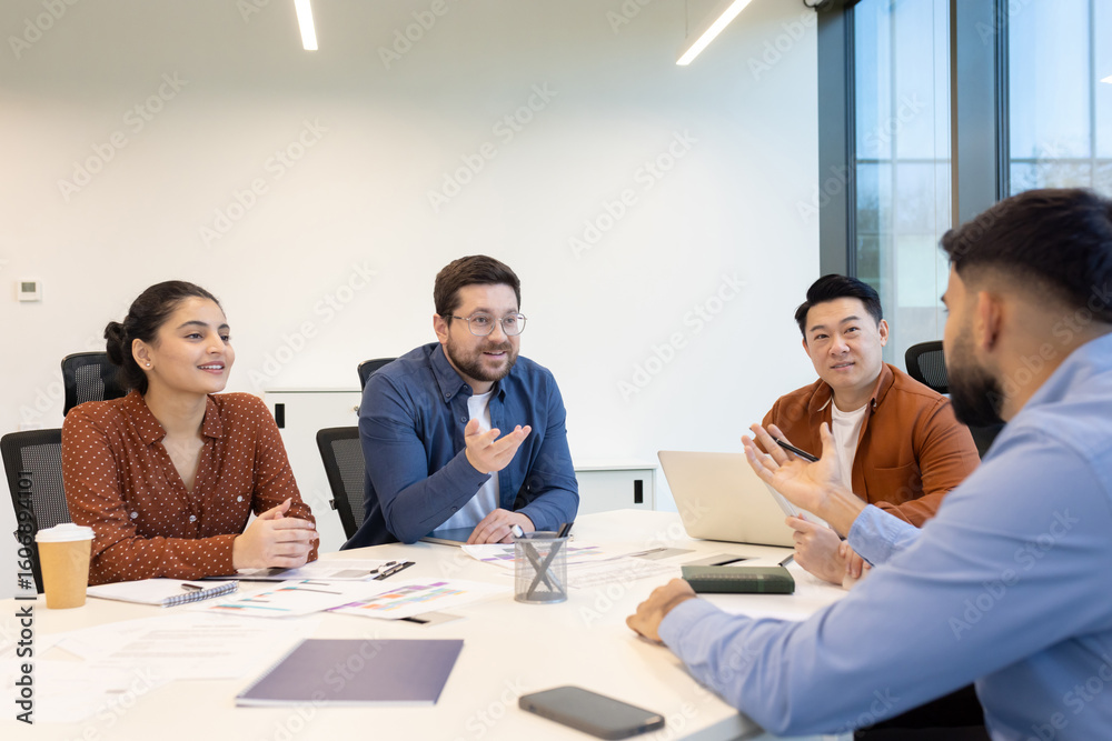 Diverse business team engaged in a meeting, discussing ideas and ...