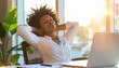 © True Stock - Confident Black woman sitting in a relaxed pose at her desk in a bright and stylish workspace
