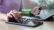 © K2L Family - Hand touching tablet with payment successful message and financial icons, representing digital transaction, mobile payment, and online wallet system.