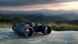 © Oleg - Exploring nature with binoculars and a map at sunset in a serene outdoor setting