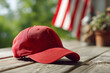 © Eko - Red baseball cap on wooden surface with patriotic background elements