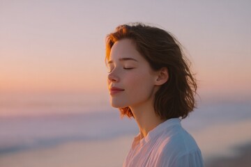 Poster - woman stands on serene beach at sunrise eyes closed embracing morning light representing tranquility of intuitive awakening