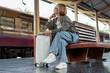 © PIC SNIPE - Happy Asian senior boarding a train at the station