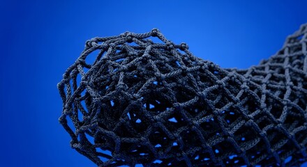 Poster - Intricate Knotted Netting - Close-up of dark blue netting with complex knotting, creating a textured and abstract design against a solid blue background