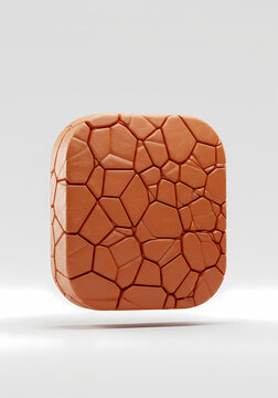 Textured Orange Rounded Square with Cracked Pattern on White Surface
