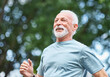 © Lumos sp - Smiling active mature elderly man jogging running in the park