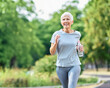 © Lumos sp - Smiling active mature elderly woman jogging running and holding a water bottle  in the park
