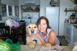 © Mat Hayward - Happy woman hugging her golden retriever dog in the kitchen