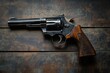 © Md Nurul - A revolver handgun with a wooden grip lying on a dark wooden surface in a horizontal orientation